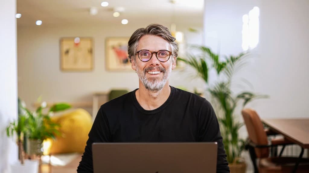 Gregory John teaching from his laptop